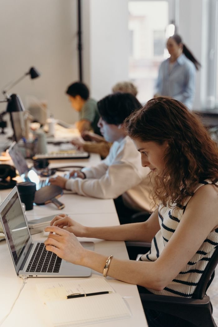 Home Team of diverse professionals collaborating in a modern office setting.
